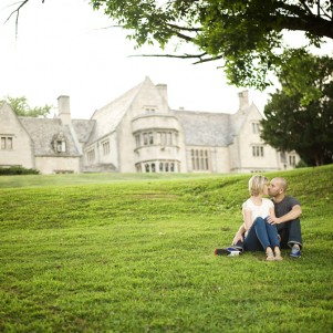 couple sit and chat in the grass on the hartwood acres estate