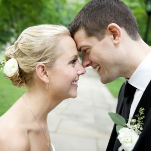 wedding couple touch foreheads for a posed portrait