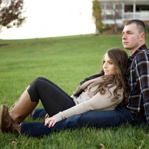 engaged couple laying in country grass