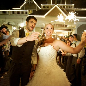 bride and groom holding sparklers outside of grand tradition estates mansion