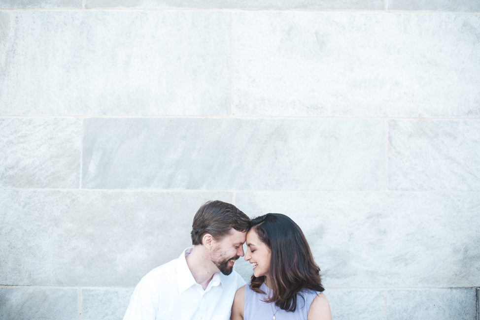 mellon park engagement session couple kissing by wall